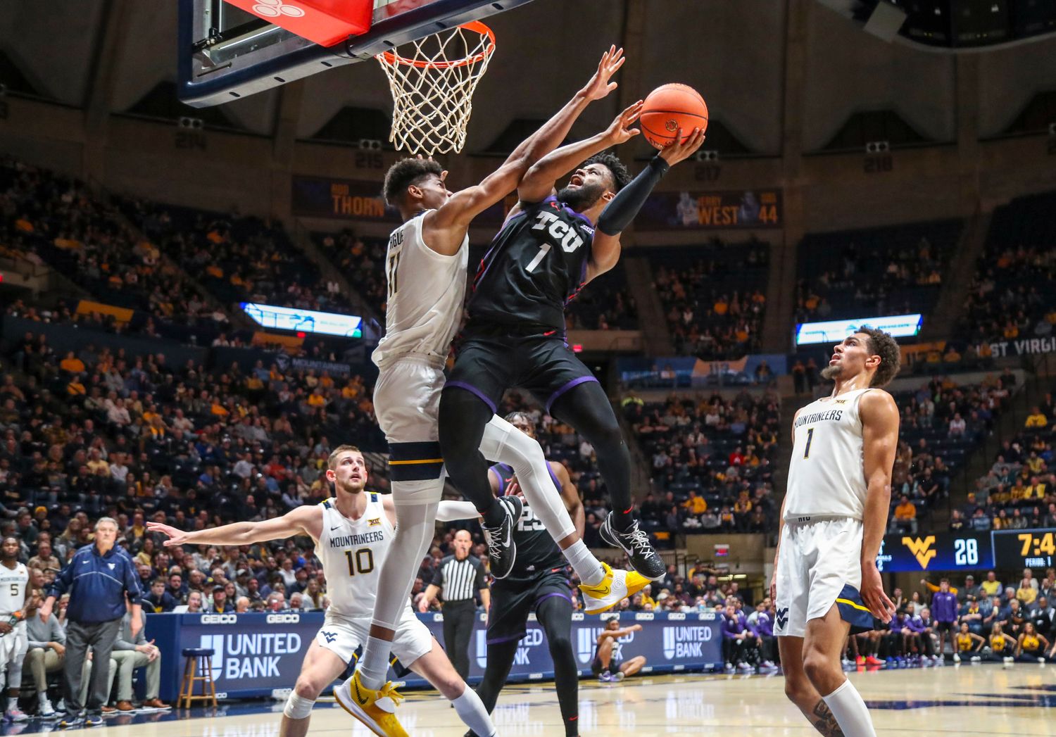 Jan 18, 2023; Morgantown, West Virginia, USA; TCU Horned Frogs guard Mike Miles Jr. (1) shoots against West Virginia Mountaineers forward Mohamed Wague (11) during the first half at WVU Coliseum.